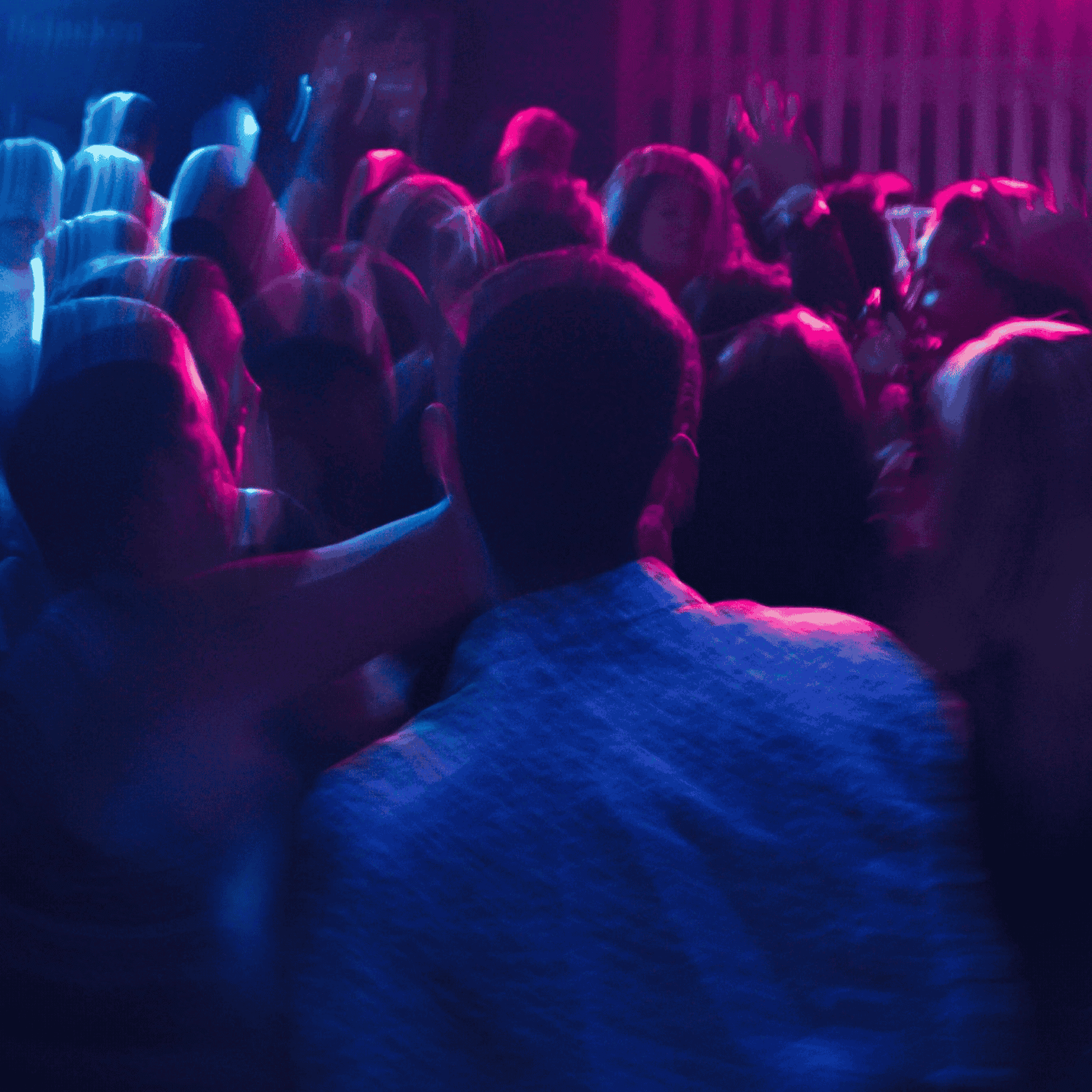 Out of focus photo of people dancing in a nightclub