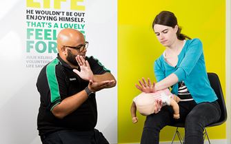 St John Ambulance trainer teaching baby first aid