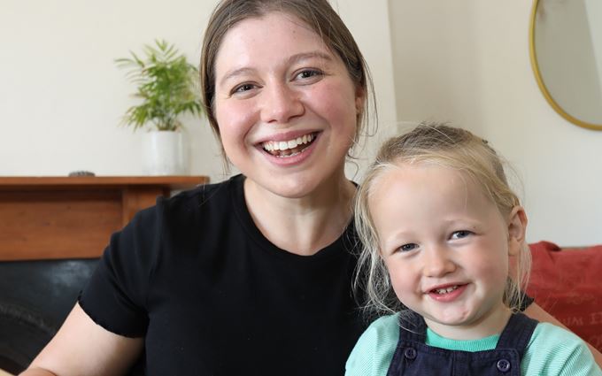 Beth smiling and holding her nephew