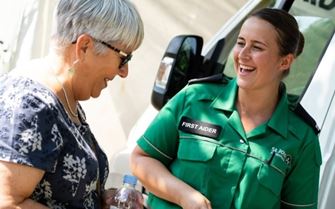 Volunteer smiling with a member of the public.