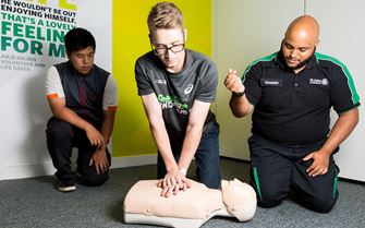 First aider teaching CPR
