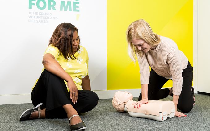 Course participants practicing child CPR using a training mannequin