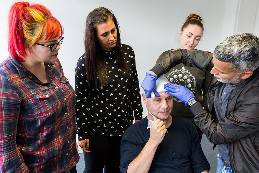 Delegates learning how to apply a head bandage