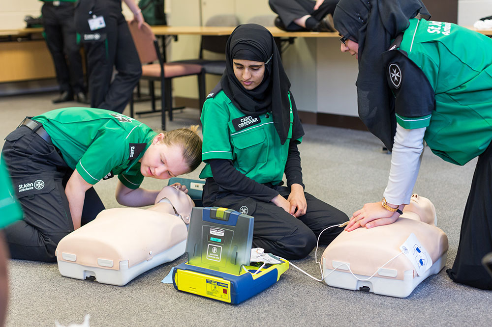Peer educator teaching first aid