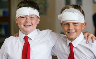 Two school children with bandages on their heads