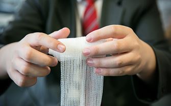 School pupil learning first aid