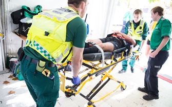 Volunteers helping a casualty at a half marathon