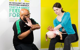 SJA trainer teaching baby first aid