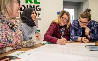 Class members brainstorming workplace safety and risks on an IOSH Managing Refresher course. 