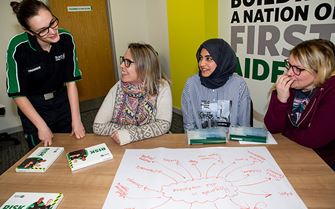Course participants collaborating on a diagram on an IOSH Working Safely training course.