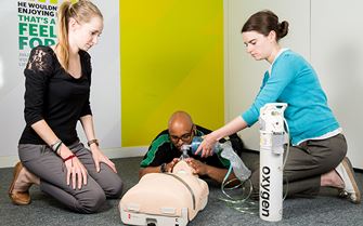 Course participants practicing how to administer oxygen.