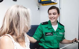 Cadet talking to member of public in ambulance