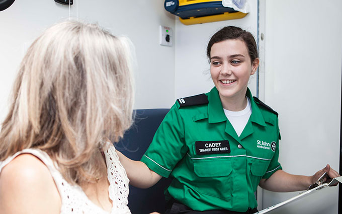 Cadet talking to member of public in ambulance